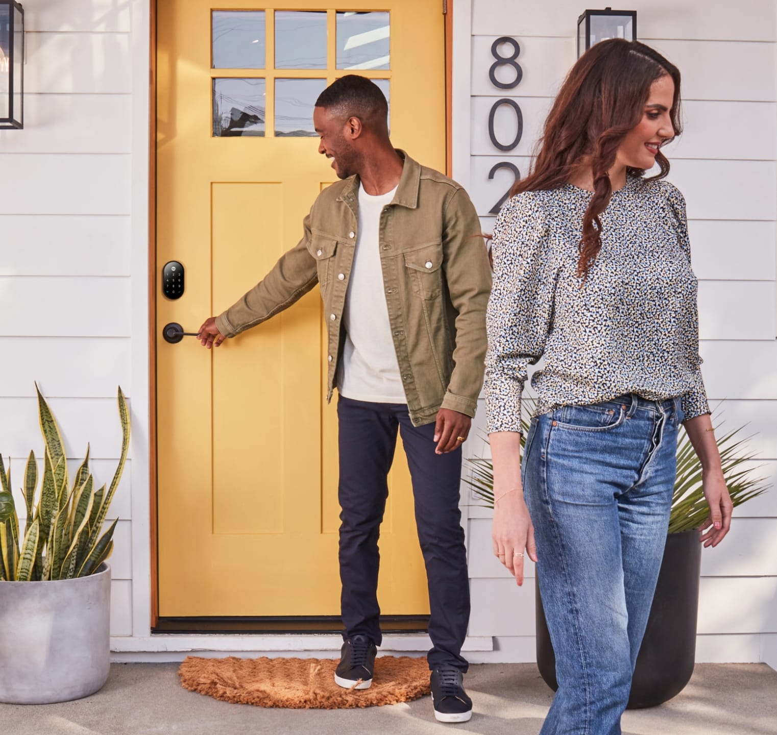 Couple leaving their home knowing that their smart cabinet lock with secure their personal belongings