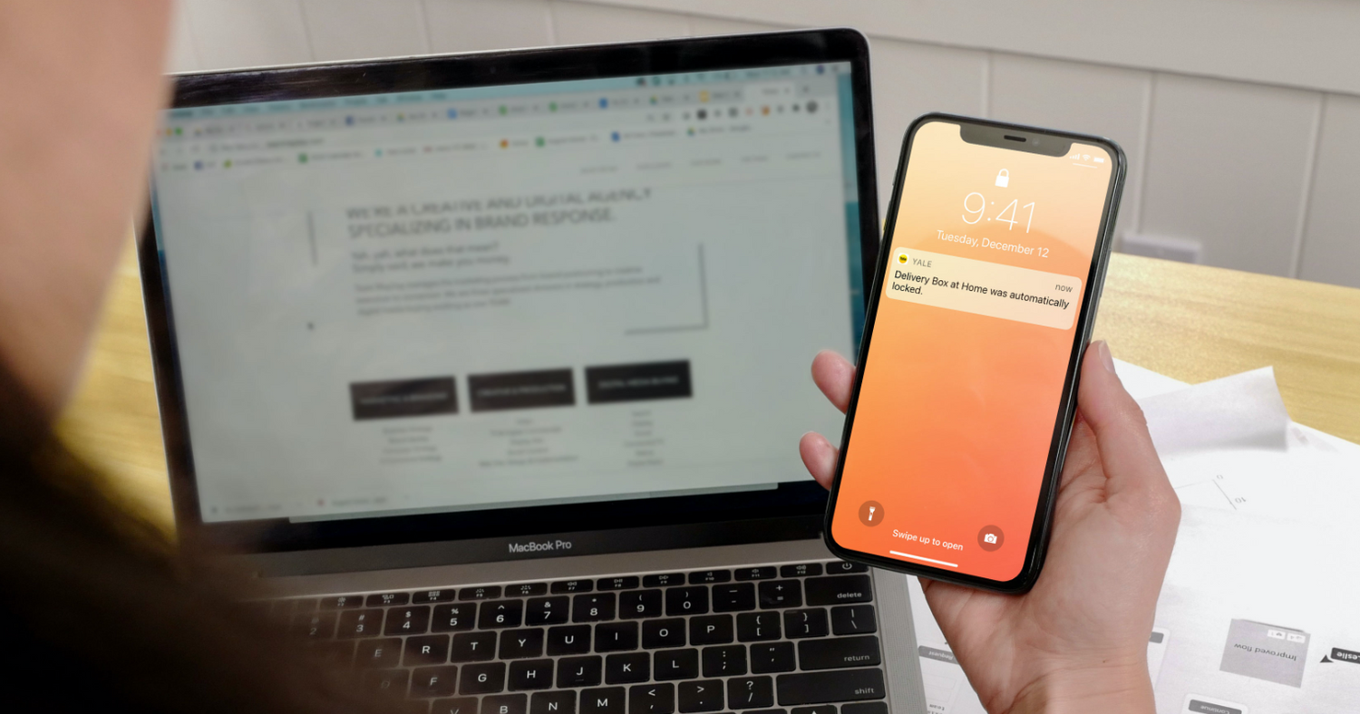 phone showing man getting a notification on his phone showing his package has been delivered to his secure Yale Drop Box on the Yale Access App