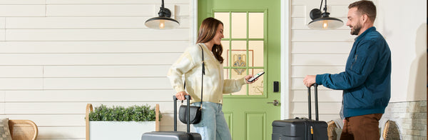 woman and man checking into Airbnb with Yale lock