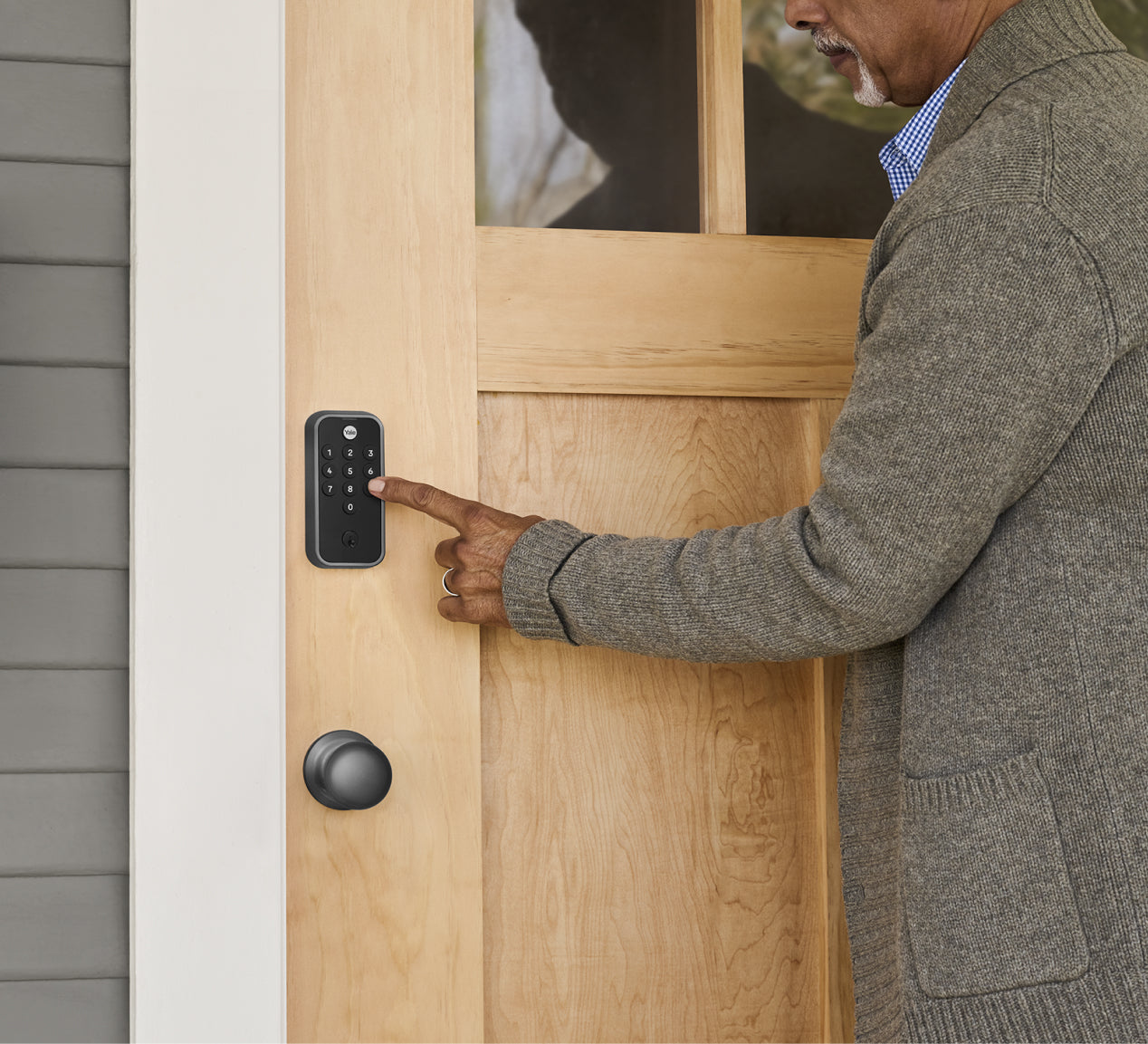 man using yale code keypad lock