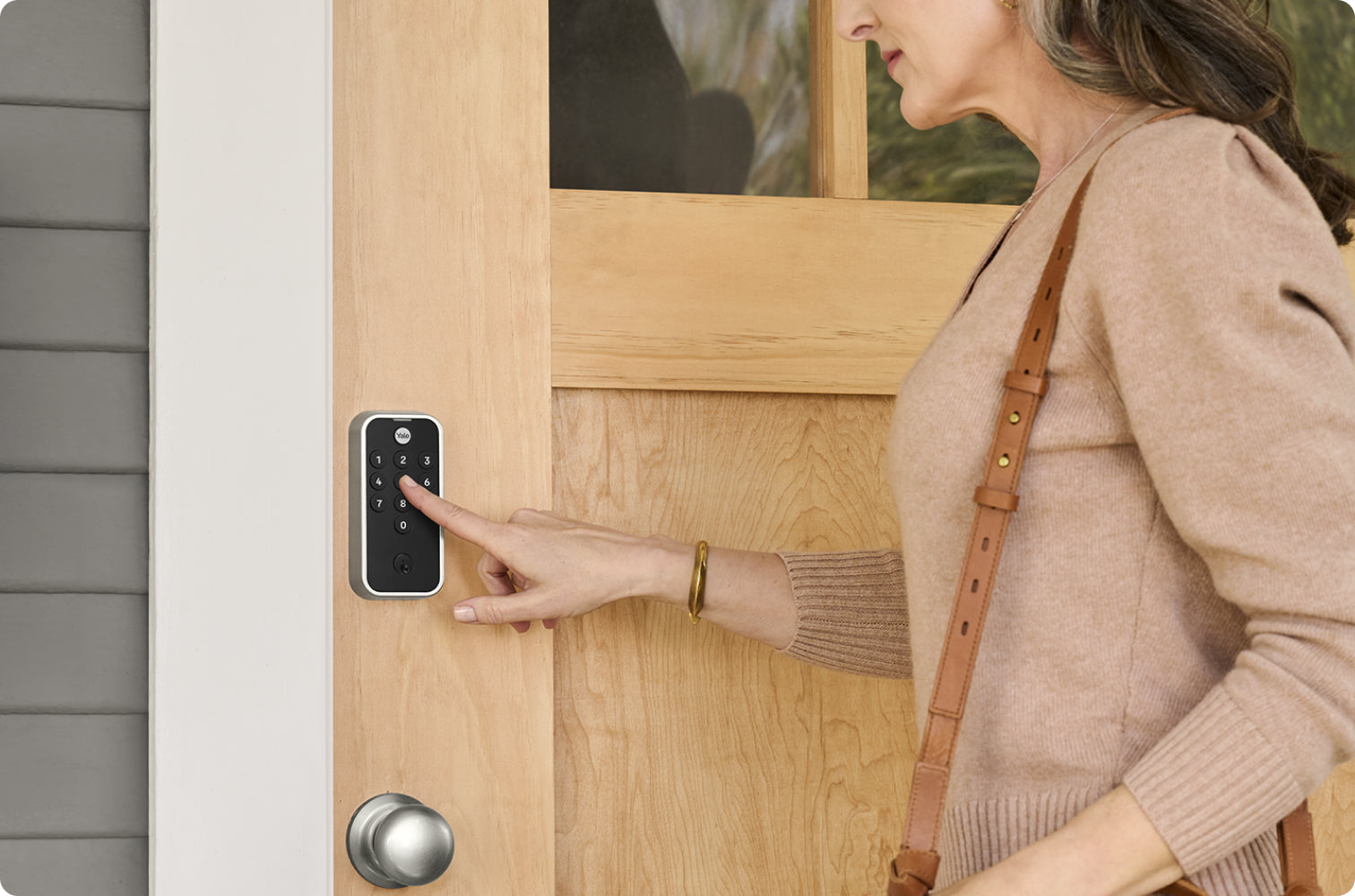 woman using yale code keypad