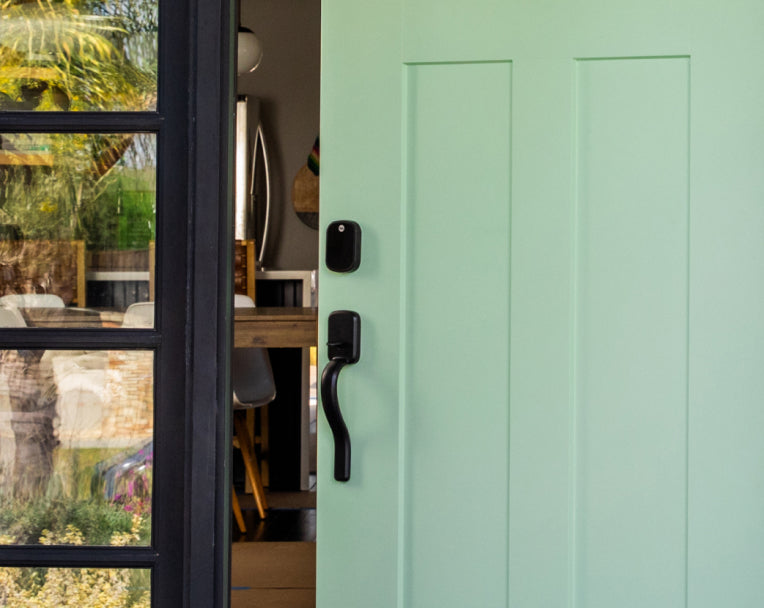 Green front door with smart lock.